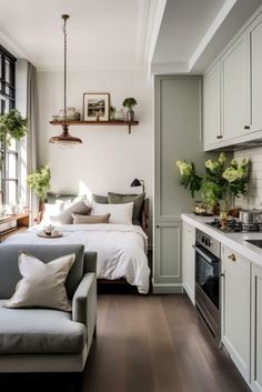 a living room filled with furniture next to a kitchen