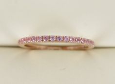 Pictures do NO justice to this band. ******************************************This gemstone half-set band is the perfect complement to any engagement ring or as stackable bands. Based on Ring Size: 5.5The half-set band crafted in solid 18k rose gold set with 0.20cts of natural Light pink sapphires.Band Measures approx. 1.4 mm width & 1.6mm in thicknesses.Carat weight varies depending on your requested ring size.************************************************************Beautiful Ring Box Inclu Luxury Half Eternity Pink Sapphire Jewelry, Luxury Pink Sapphire Round Band Ring, Luxury Pink Half Eternity Stackable Rings, Luxury Pink Sapphire Eternity Band, Luxury Pink Sapphire Eternity Band For Engagement, Half Eternity Pink Sapphire, Pink Sapphire Ring Gold Band, Luxury Pink Eternity Band For Anniversary, Pink Quartz Wedding Band