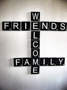 a cross made out of scrabble tiles with the words friends and family on it