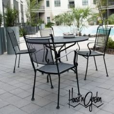 an outdoor dining table and chairs on a patio