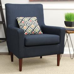 a blue chair sitting next to a table with a potted plant on it