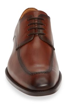 A tapered moc toe elongates the frame on this formal-ready derby set on a half-rubber sole for traction and versatility. 1 1/4" heel (size 11) Lace-up style Injected memory foam insole Arch support Leather upper and lining/leather and rubber sole Made in Spain Brown Snip Toe Dress Shoes For Semi-formal Occasions, Cognac Plain Toe Oxfords For Business Casual, Timeless Brown Derby Shoes For Business, Timeless Brown Derby For Business, Timeless Brown Derby For Formal Occasions, Cognac Goodyear Welted Dress Shoes For Semi-formal Occasions, Fitted Cognac Oxfords With Leather Sole, Elegant Moc Toe Derby For Business Casual, Timeless Cognac Dress Shoes For Semi-formal Occasions