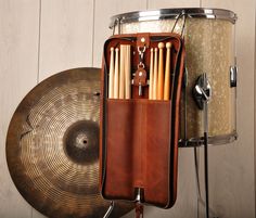 a drum case with sticks and drums in it