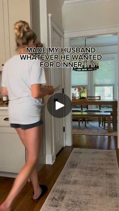 a woman is standing in the kitchen with her legs crossed and looking at something on the floor