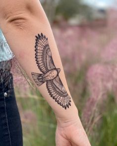 a person with a bird tattoo on their arm