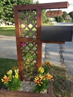 an outdoor mailbox with flowers in it