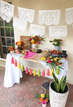 a table topped with flowers and tassels next to a sign that says how to set up a chip and dip bar for fiesta party