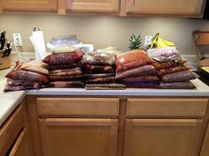 bags of food are stacked on top of each other in the kitchen countertop area