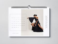 a calendar with an image of a woman in a black dress