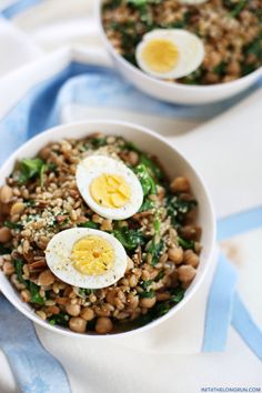 two bowls filled with rice, beans and hard boiled eggs on top of each other