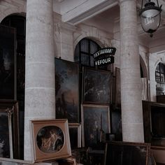 there are many paintings on the wall in this room and one has a sign that says restaurant vefour