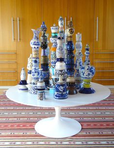 a table topped with lots of blue and white vases