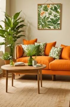 a living room with orange couches and green plants