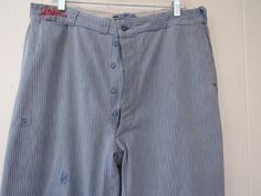 "Vintage 1930s work pants. Made of blue and white hickory striped cotton denim. Has button fly, two front pockets, small pocket and two rear pockets. Embroidered \"John\" on the waistband. Linen service label, but no manufacturer's label. Actual measurements are: 36\" around the waist 31.5\" inseam 43.5\" overall length In good condition with some old repairs and some spots." Striped Cotton Bottoms With Buttons, Vintage Striped Straight Leg Bottoms, Striped Cotton Bottoms With Button Closure, Vintage Striped Bottoms For Workwear, Vintage Cotton Bottoms With Vertical Stripes, 1930s Pants, Workwear Vintage, Striped Denim, Vintage Workwear