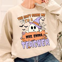 Custom Name Teacher Shirt, You Can't Scare Me Im A Teacher Shirt, Spooky Teacher Shirt, Halloween Teacher Shirt, Cute Ghost Teacher Shirt 👉 DISCLAIMER - Colors in listings may slightly vary depending on what device you are using - Prints may appear smaller depending on the shirt size ordered 👉 PRODUCT DETAILS: ★ GILDAN® 18000 Unisex Heavy Blend™ Crewneck Sweatshirt This well-loved sweatshirt is the perfect addition to any collection! The air-jet spun yarn and quarter-turned fabric helps elimin Colorful Table, Unisex Tshirt, Cute Ghost, I Am Scared, Air Jet, Teacher Shirts, Cold Day, Custom Name, Pocket Pouch