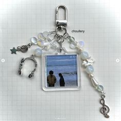 a key chain with a photo and charms attached to it