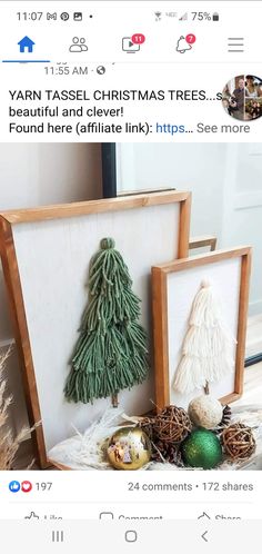 two christmas trees are displayed in wooden frames