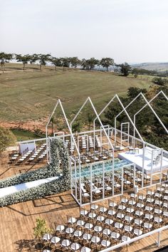 an aerial view of a wedding venue set up with chairs and tables next to the pool