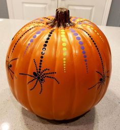 an orange painted pumpkin sitting on top of a counter