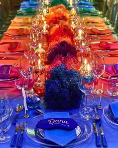 a long table is set with place settings for dinner