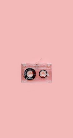 a pink cassette with two discs on it