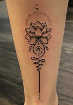 a woman's leg with a tattoo on it and a flower in the center