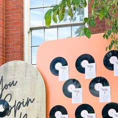 there are many records on the side of this building that is decorated with black and white paper