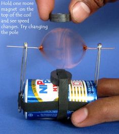 someone is making a miniature lightbulb out of an old soda can and some magnets