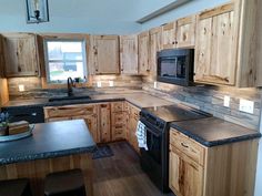 a kitchen with wooden cabinets and black appliances