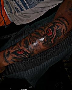 a man with a tiger tattoo on his arm