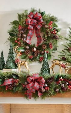 a christmas mantel decorated with evergreen, pine cones and red plaid ribbon bows is adorned with deer figurines