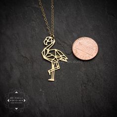 "Geometric flamingo necklace, Versatile as it is trendy, the flamingo necklace can be worn year round to spruce up your everyday outfits. ★This is the gold item, for the silver item use this link: https://www.etsy.com/listing/266316478 ♥WANT TO MAKE IT PERSONAL? ♥ Add a charm letter to your necklace - Add this item: https://www.etsy.com/il-en/listing/687931684 ★ Comes in our signature box, ready for gift giving. ★ Available in Gold [18K goldfield & gold plated brass ] ★ Pendant size :1.40\"x Geometric Flamingo, Flamingo Necklace, Jewelry Design Studio, Egyptian Necklace, Tropical Jewelry, Egyptian Jewelry, Dog Necklace, Geometric Necklace, Unique Jewelry Designs