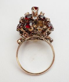 This is a very old piece, you can tell just from the cut of the stones. I would say possibly as early as 1900-1910, but I'm not sure when this style first came about so I cannot This is a Thai Princess ring. The original style was designed to be able to switch out the tops to give the same ring a different look. This ring is not made that way. This ring is not changable, it is the way it is. There are 15 red stones that are garnets, and the stones are round, but not very precisely cut just due t Flashy Engagement Rings, Garnet Wedding Rings, Garnet Wedding, Weird Jewelry, Red Stones, Princess Ring, Diamond Wedding Sets, Fine Jewelery, Garnet Ring