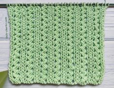 a green crocheted dishcloth hanging from a hook