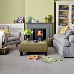 a living room filled with furniture and a fire place in the middle of the room