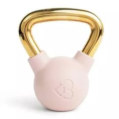 a pink and gold kettle with a handle on it's side, against a white background