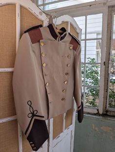 This vintage marching band uniform jacket has a great historical look to it, making it ideal for a wide range of costumes. Soft, fine wool polyester blend. Snaps on the shoulders for adding a sash. In good condition with some missing buttos and areas of discoloration. 18 inches across the shoulders, 18 inches across the chest. 23 inches long. Vintage Outerwear With Epaulettes For Costume, Vintage Costume Outerwear With Epaulettes, Military Outerwear With Epaulettes For Costume, Fitted Outerwear With Epaulettes For Costume, Fitted Long Sleeve Military Uniforms, Fitted Long-sleeved Military Uniforms, Winter Formal Blazer With Epaulettes, Military Uniforms Long Sleeve Formal, Military Style Fitted Uniform For Formal Occasions