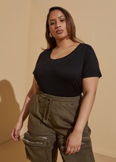 This smooth scoop neck tee that's easy fitting and super versatile. Whether you pair it with jeans or dress pants, your look will be chic and comfortable. Shop this wardrobe essential that's anything but basic at Ashley Stewart. Plus Size Trendy, Plus Size Tees, Plus Size T Shirt, Scoop Neck Tee, Ashley Stewart, Simple Fashion, Line Store, Knit Tees, Basic Tops