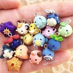 a hand holding a bunch of small toy animals