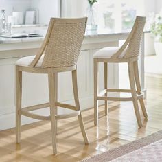 two stools sitting in front of a kitchen counter