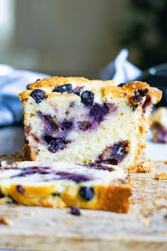 a loaf of blueberry bread sitting on top of a cutting board