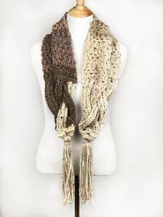 a white mannequin with two scarves on it