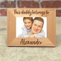 a wooden frame with the words, this daddy belongs to alexandria