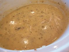 a white bowl filled with soup sitting on top of a table