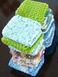 a stack of crocheted dishcloths sitting on top of a black table