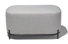 a grey ottoman sitting on top of a metal frame