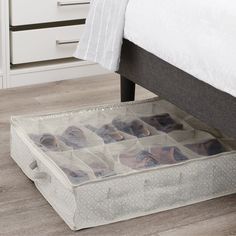 a bed with drawers underneath it on the floor