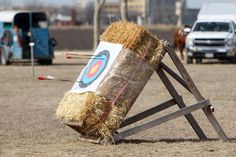 an archery target is placed on top of a hay bale with arrows in it