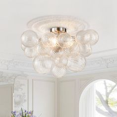 a bathroom with a sink, mirror and chandelier in the middle of it