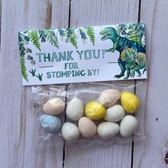 a plastic bag filled with easter eggs next to a sign that says thank you for stomping by